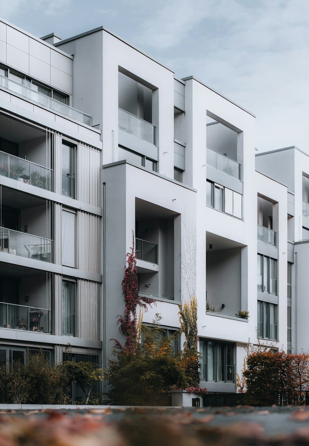 Modern apartment building with ivy climbing the concrete walls.