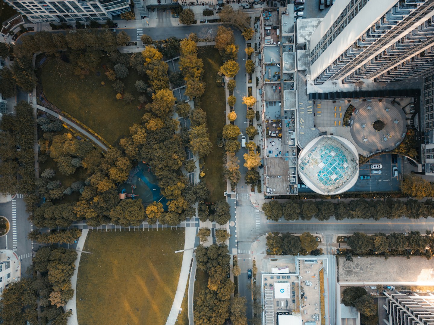 Aerial view of a modern city park surrounded by buildings.
